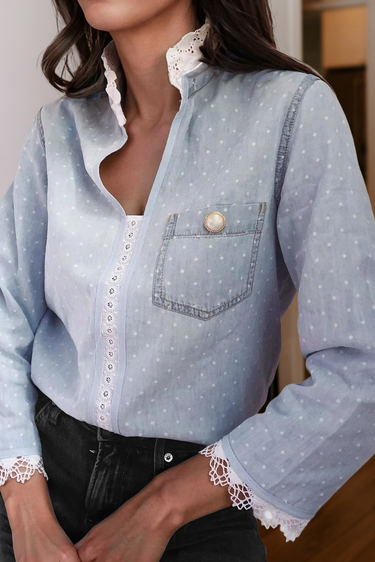 Light blue polka dot button-up blouse with lace trim and pearl button pocket – women’s chic casual top.